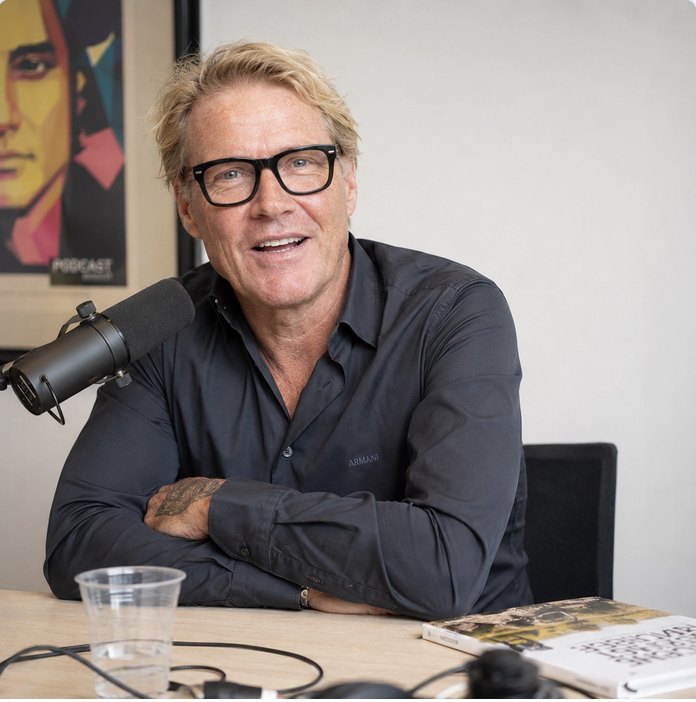Podcast host at a desk with a broadcast microphone